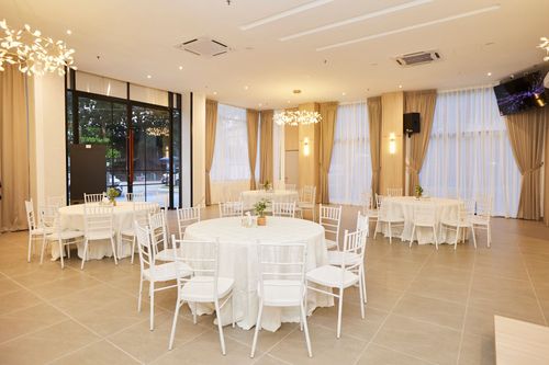 Elegant event hall with chandeliers and stage
